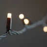 Гирлянда Нить 10м Тепло-Белая с Мерцанием Белого Диода 220В, 100 LED, Провод Черный Каучук, IP65. Фото 5.