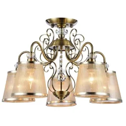 Серия из металла цвета античной бронзы. Арматура светильников Driana дополнена завитками на рожках и узогнутым декором в центральной части. Абажуры из полупрозрачной органзы выполнены в виде колокольчиков и обрамлены ободками из металла. (Бронза Антик)