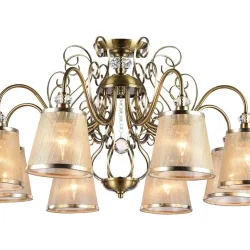 Серия из металла цвета античной бронзы. Арматура светильников Driana дополнена завитками на рожках и узогнутым декором в центральной части. Абажуры из полупрозрачной органзы выполнены в виде колокольчиков и обрамлены ободками из металла. (Бронза Антик)
