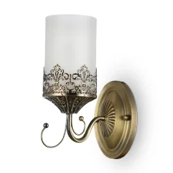 Нарядные и элегантные светильники — прекрасное решение для интерьеров в классическом стиле. Металлическая арматура окрашена в бронзовый цвет, цилиндрические плафоны из матового стекла обрамлены резным узором из металла, который перекликается с орнаментом 