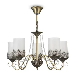 Нарядные и элегантные светильники — прекрасное решение для интерьеров в классическом стиле. Металлическая арматура окрашена в бронзовый цвет, цилиндрические плафоны из матового стекла обрамлены резным узором из металла, который перекликается с орнаментом 