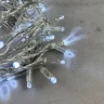 Гирлянда Нить с Колпачком 10м Белая с Мерцанием Белого Диода 24В, 100 LED, Провод Прозрачный ПВХ, IP65. Фото 2.