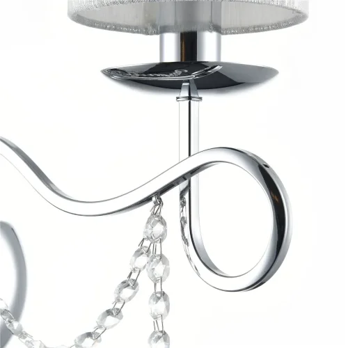 Нарядные и изящные светильники Morel выполнены в классическом стиле. Светлые абажуры сделаны из органзы, арматура – из металла цвета 'хром'. Каждый из светильников этой серии декорирован хрусталем в виде лент из кристаллов в форме октагонов и шара. (Хром)