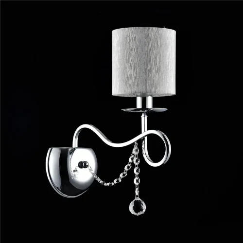 Нарядные и изящные светильники Morel выполнены в классическом стиле. Светлые абажуры сделаны из органзы, арматура – из металла цвета 'хром'. Каждый из светильников этой серии декорирован хрусталем в виде лент из кристаллов в форме октагонов и шара. (Хром)