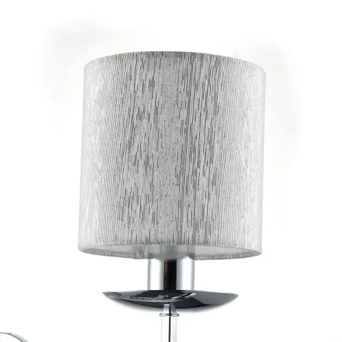 Нарядные и изящные светильники Morel выполнены в классическом стиле. Светлые абажуры сделаны из органзы, арматура – из металла цвета 'хром'. Каждый из светильников этой серии декорирован хрусталем в виде лент из кристаллов в форме октагонов и шара. (Хром)