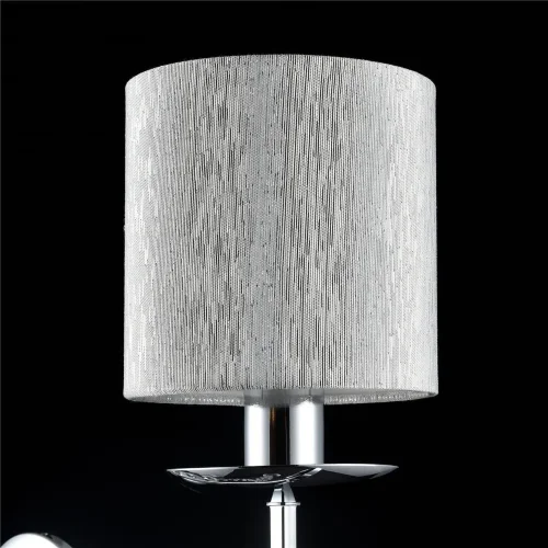 Нарядные и изящные светильники Morel выполнены в классическом стиле. Светлые абажуры сделаны из органзы, арматура – из металла цвета 'хром'. Каждый из светильников этой серии декорирован хрусталем в виде лент из кристаллов в форме октагонов и шара. (Хром)